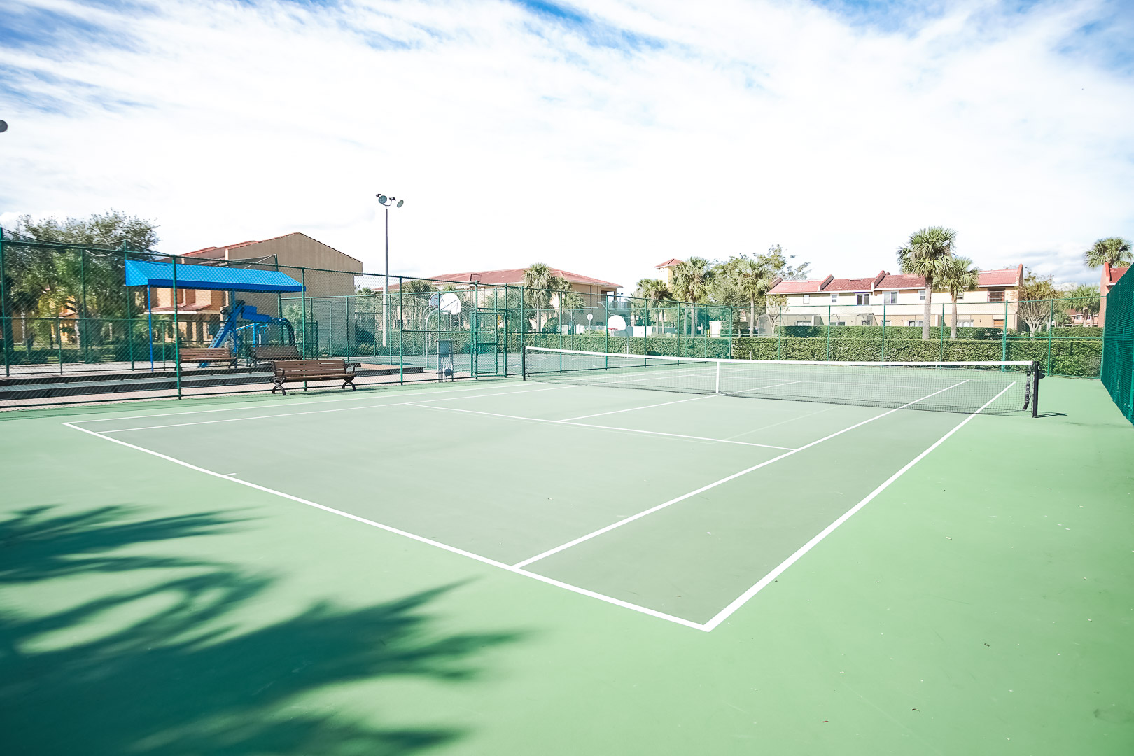 An expansive view of the tennis court at VRI's Fantasy World Resort in Florida.